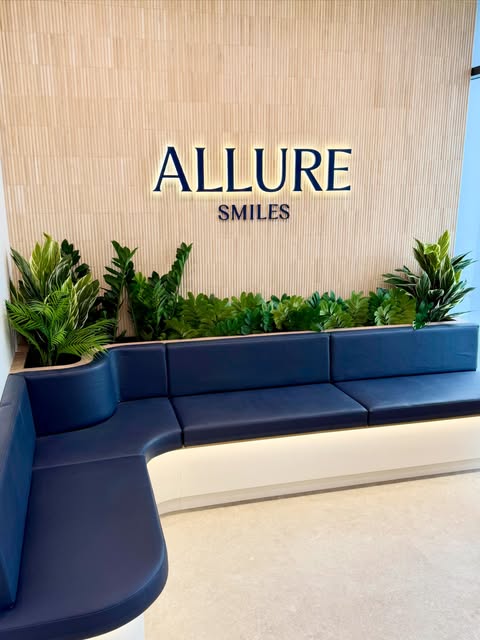 The waiting area at Allure Smiles with the practice logo, from the practice's published photography